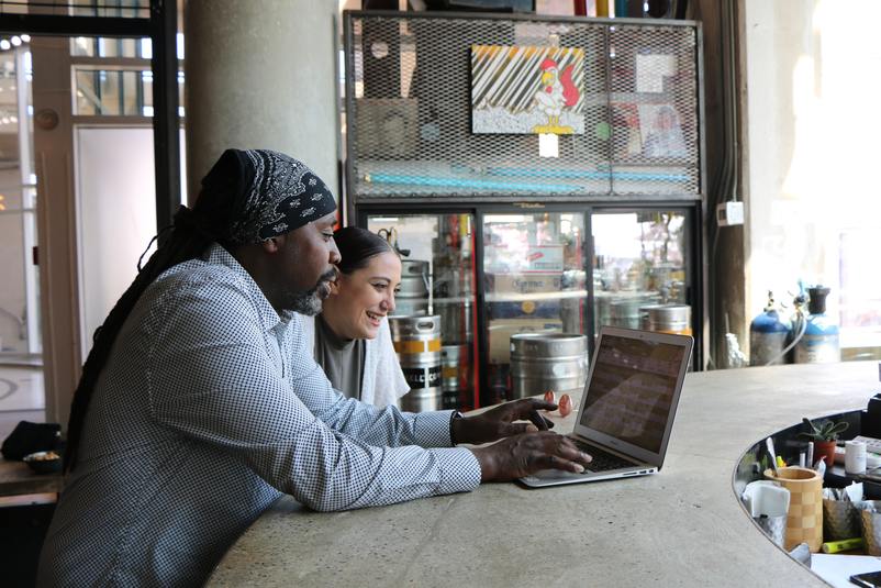 Timesheet Template - two people at laptop